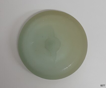Cap liner glass has imperfections. There is a grp in the centre 