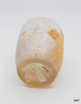 Base is slightly pushed up, glass near base has ripples.Two stickers on glass base.