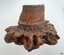 Bases of the spokes are still joined onto the hub. The centre has been carved to allow for the axel to fit on.