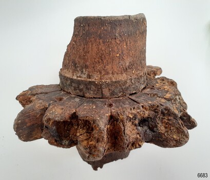 Bases of the spokes are still joined onto the hub. The centre has been carved to allow for the axel to fit on.