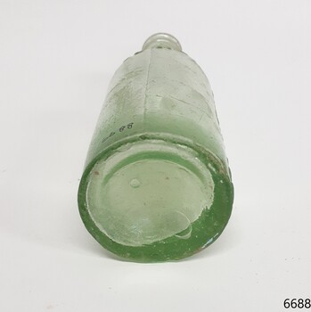Base has varying glass thickness, large and small bubbles, body has a side seam