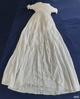 Bodice and centre of white christening gown have Broderie Anglaise fabric