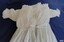 Back opening has ribbon tie closure