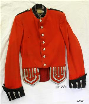 Red jacket has gold buttons, black collar, epaulettes and cuffs