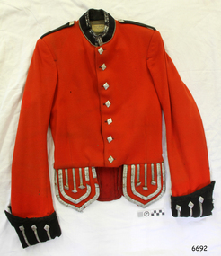 Red jacket has gold buttons, black collar, epaulettes and cuffs