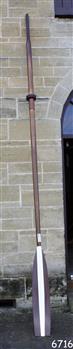 Timber oar with blade painted brown and white