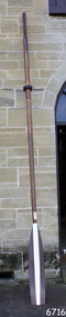 Timber oar with blade painted brown and white