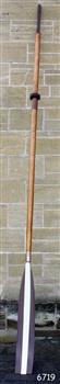 Wooden oar with brown and white painted blade