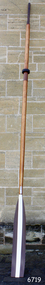 Wooden oar with brown and white painted blade