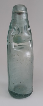 Another angle of the upright codd bottle showing its uneven base
