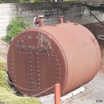 Boiler's enclosed end, sides and top, showing rivets and pipes