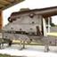 Cannon mounted on wooden carriage, undercover.