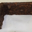 Right angle iron piece is rusting and crumbling. 