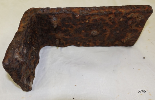 Right angle iron piece is rusting and crumbling. 