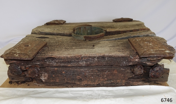 Timber and metal fixtures are flaking and fragile. The centre of the top piece of timber is worn and concave.