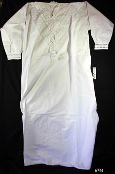 White nightgown with long straight body and long sleeves. Lace decoration