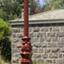 An old style gas lamp light on a wrought iron post.