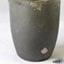 Crucible was created from grey clay. There are some encrustations on the surface.