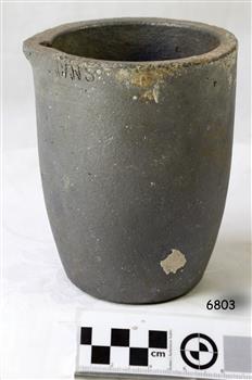 Crucible was created from grey clay. There are some encrustations on the surface.