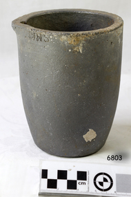 Crucible was created from grey clay. There are some encrustations on the surface.