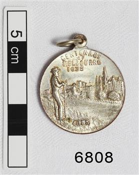 Medal is engraved with text and images