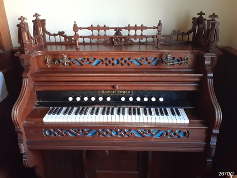 View of keyboard with five octaves, twelve stops and maker's name