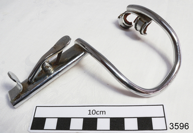Stainless steel mouth gag with a curved part (presumably this part goes in the mouth) and straight piece.