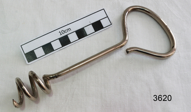 Large stainless steel 'corkscrew' with oval handle, used to remove fibroids.