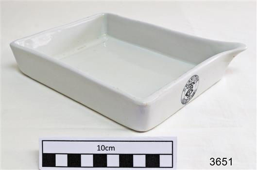 White rectangular porcelain open tray with pouring lip on one corner.