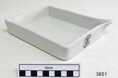 White rectangular porcelain open tray with pouring lip on one corner.
