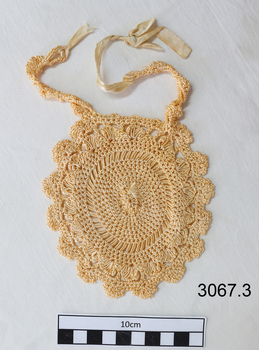 Cream coloured crocheted item with ties