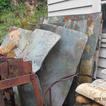 Copper sheets standing upright, one in front of the other. leaning on the west wall of the Blacksmith's building.. Current location 15-7-2021