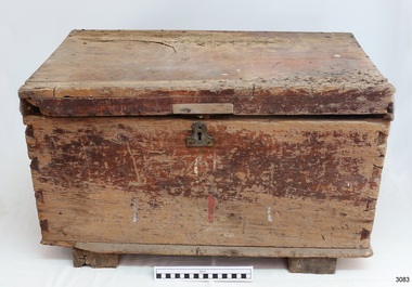 Wooden toolbox has medal keyhole on centre front. The sides have dovetail joints.