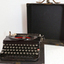 Case for typewriter is fitted. Lid removes completely. Typewriter can be used when on its base.