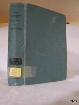 Blue hard cover book with title and library call numbers on the spine