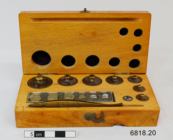 A set of 19 weights for use by an apothecary. Complete in a wooden hinged lidded wooden box, including tweezers for lifting each weight without touching it.