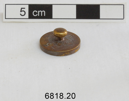 The 5 gram weight used for use by an apothecary. Part of an apothecary set of weights.