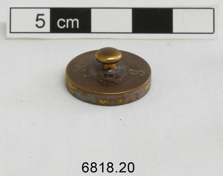 The 10 gram weight used for use by an apothecary. Part of an apothecary set of weights.