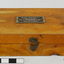 The wooden box containing 19 weights for use by an apothecary.