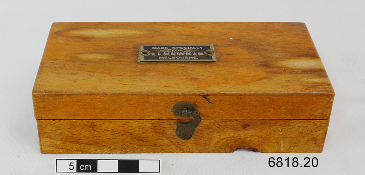 The wooden box containing 19 weights for use by an apothecary.