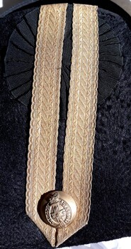 Black hat has gold braid and gold button