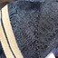 Gold braid has been added over the black lace