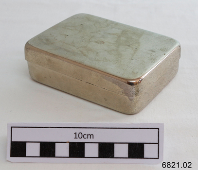 A small stainless steel rectangular container with lid. 