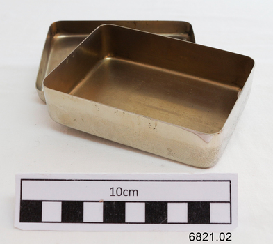 Inside the small silver rectangular container 