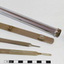 A long metal tube containing 3 copper coloured medical instruments 