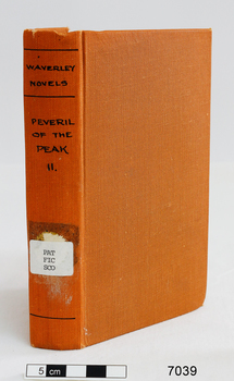 A copper coloured book with the title in black font