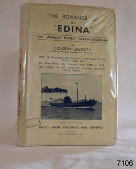 Hardcovered book with white jacked covered in plastic. Ship photograph on cover.