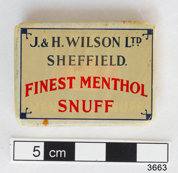 A small rectangular box with the makers name in black and the snuff words written in red