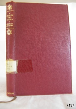 A red hard cover book with the title in gold writing 