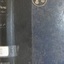 A blue hard cover with a black stripe, a golden emblem, book's name on the spine in white font
